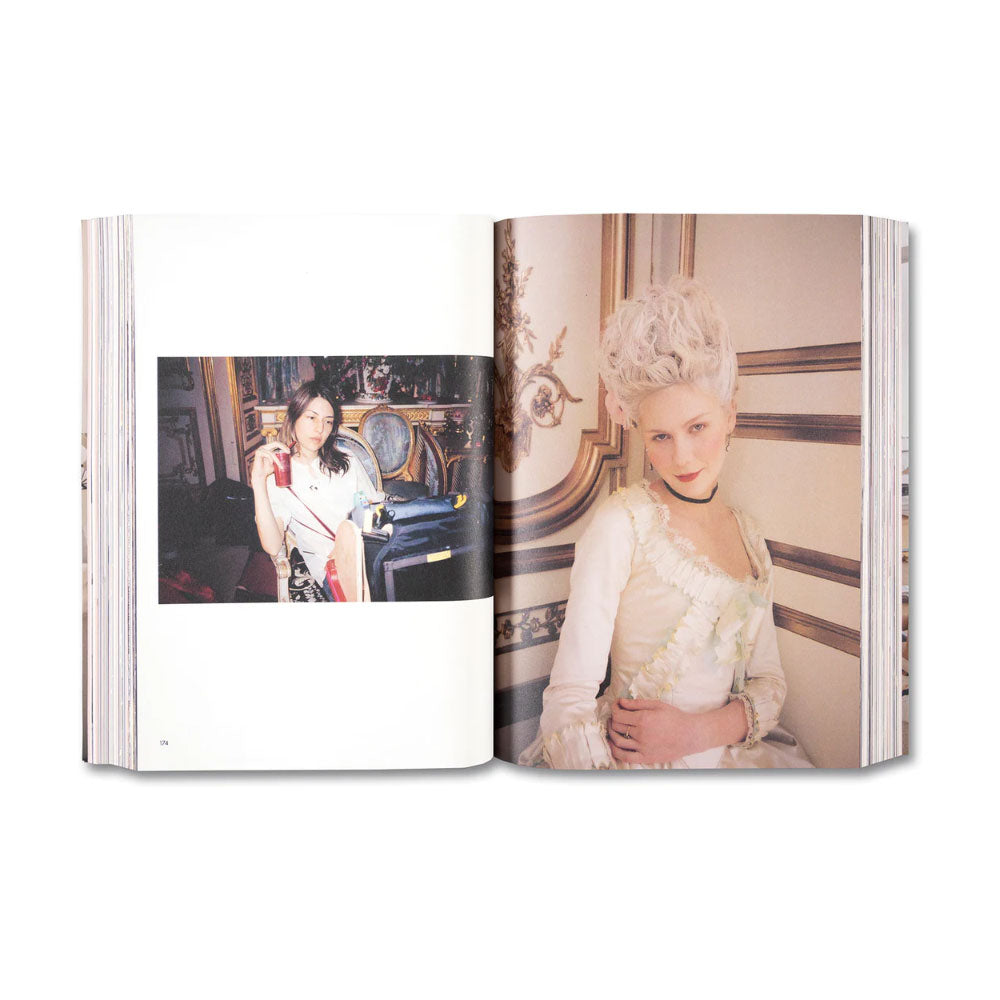 Open book showing two pages with images of a woman in elegant attire. Kirsten Dunst dressed as Marie Antoinette in Sofia Coppola's movie