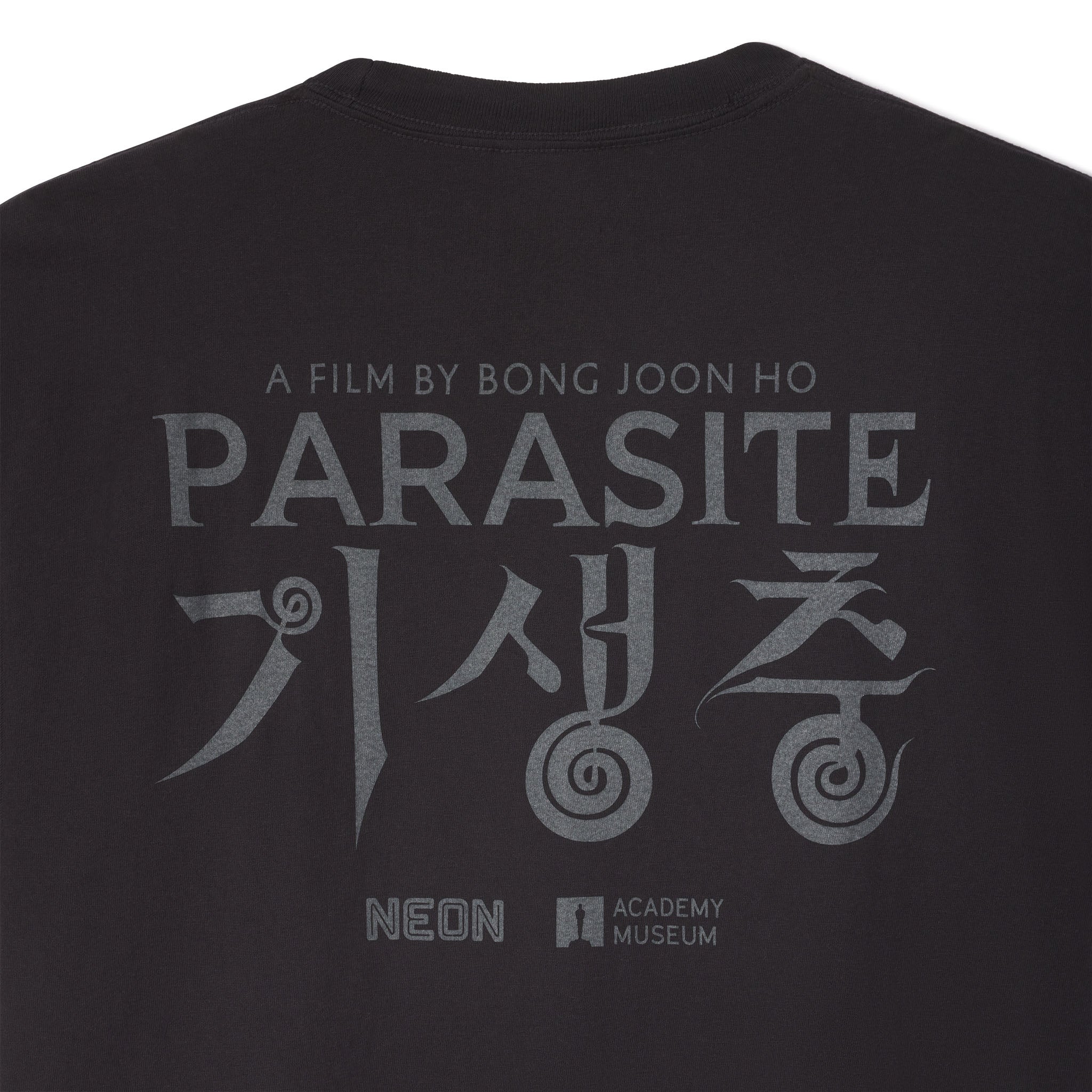 Black t-shirt with 'Parasite' movie title and branding on a white background closeup image
