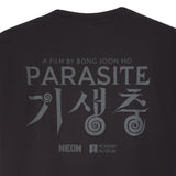 Black t-shirt with 'Parasite' movie title and branding on a white background closeup image