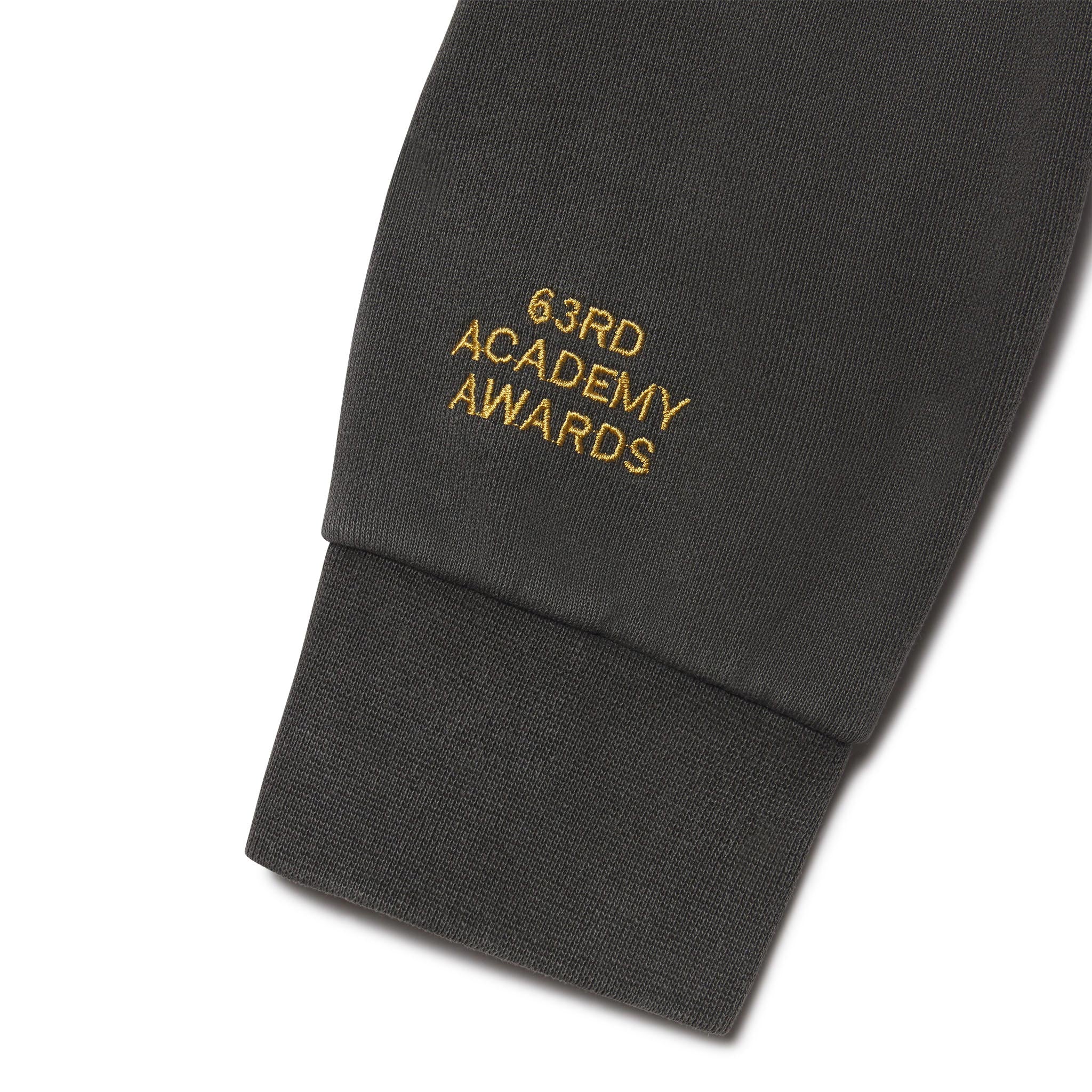 Black sweatshirt sleeve with '63rd Academy Awards' text in gold on a white background