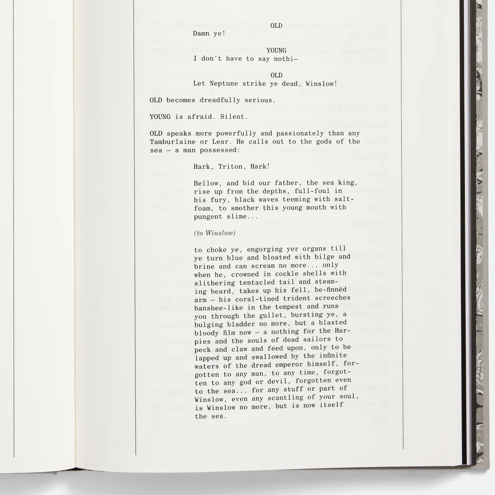 Open book with typewritten text on a white background