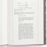 Open book with typewritten text on a white background
