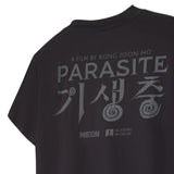 Black t-shirt with 'Parasite' movie title and logos on a white background