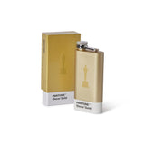 Gold flask and box with Pantone Oscar Gold color swatch on a white background