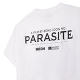 White t-shirt with 'PARASITE' text and logos on a white background closeup image