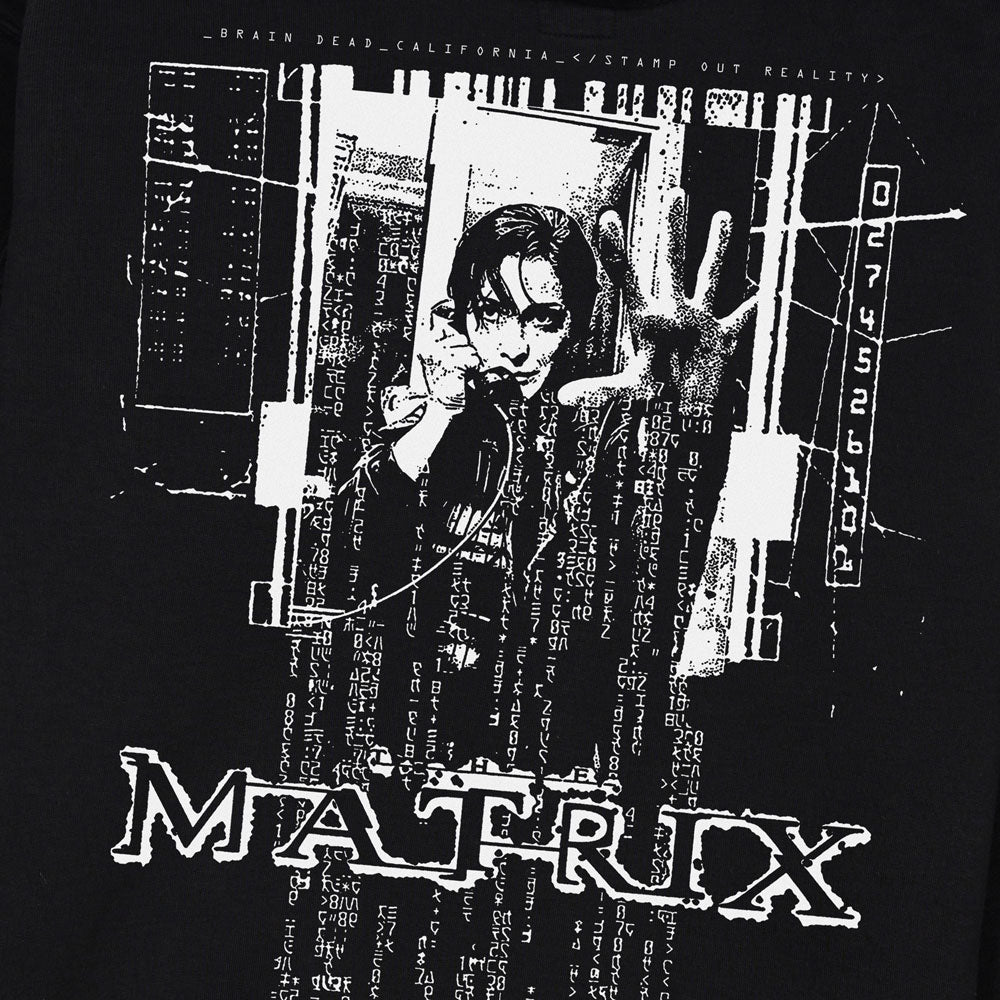 Black t-shirt with 'The Matrix' graphic design featuring a person with a hand on a screen. Exclusive graphic designed by Brain Dead Studios at the Academy Museum.