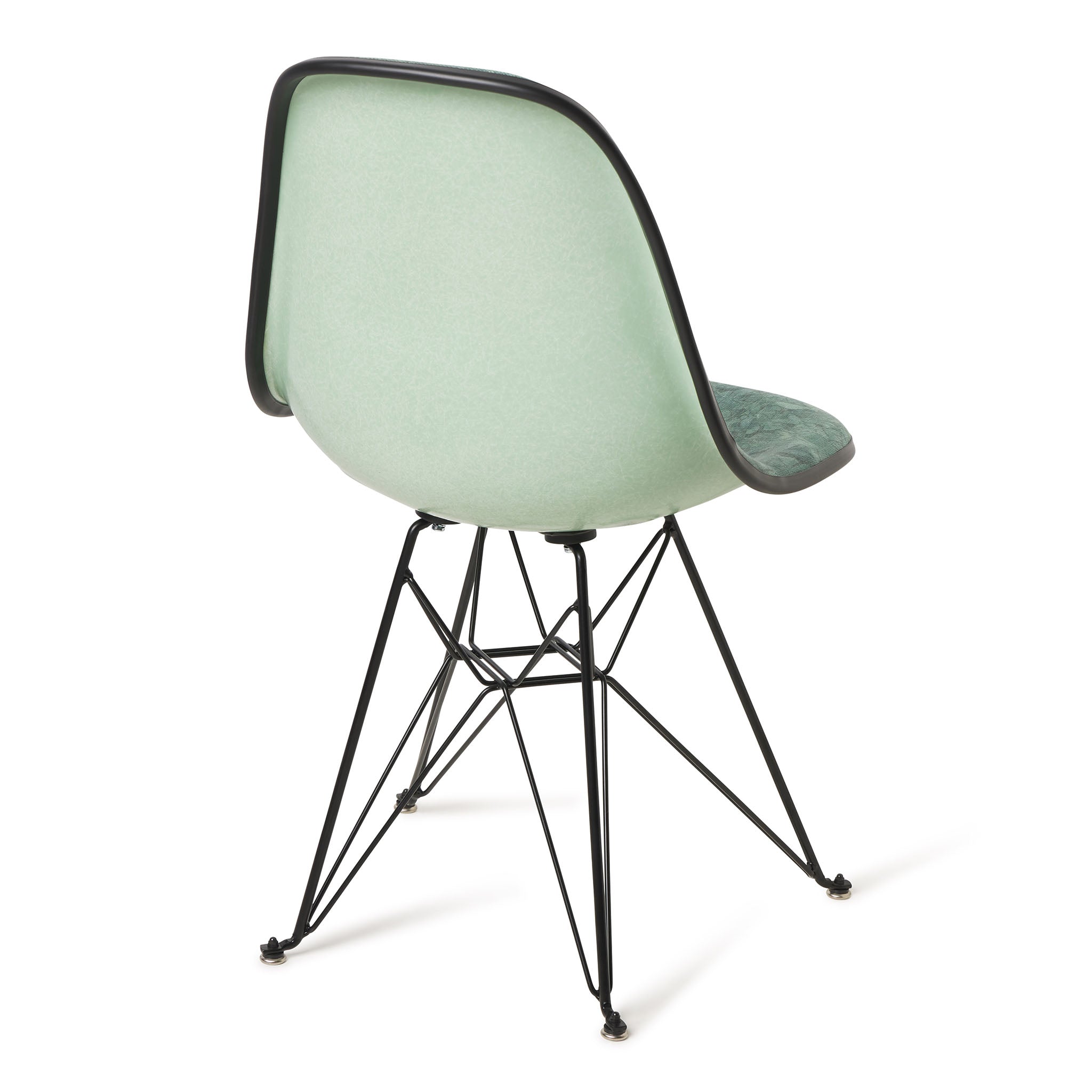 Green chair with black metal legs on a white background