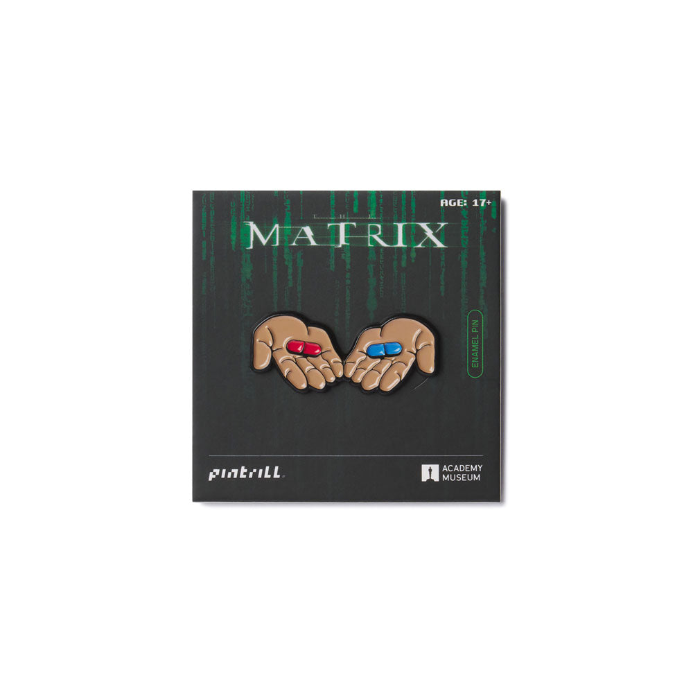 Pin featuring hands with red and blue pills on a 'Matrix' branded card. officially licensed The Matrix™ Enamel Pin