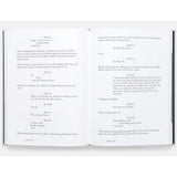 Open book with screenplay text on a white background