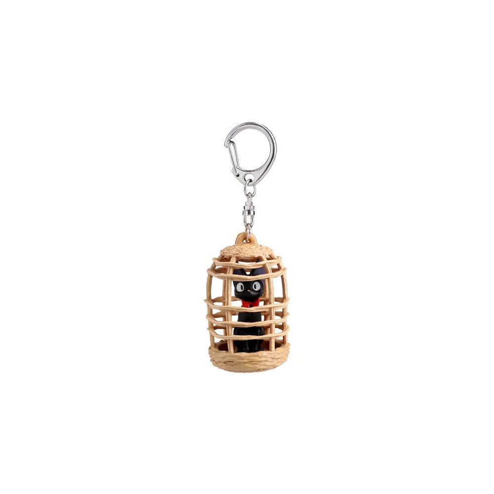 Keychain with a small black cat in a cage on a white background