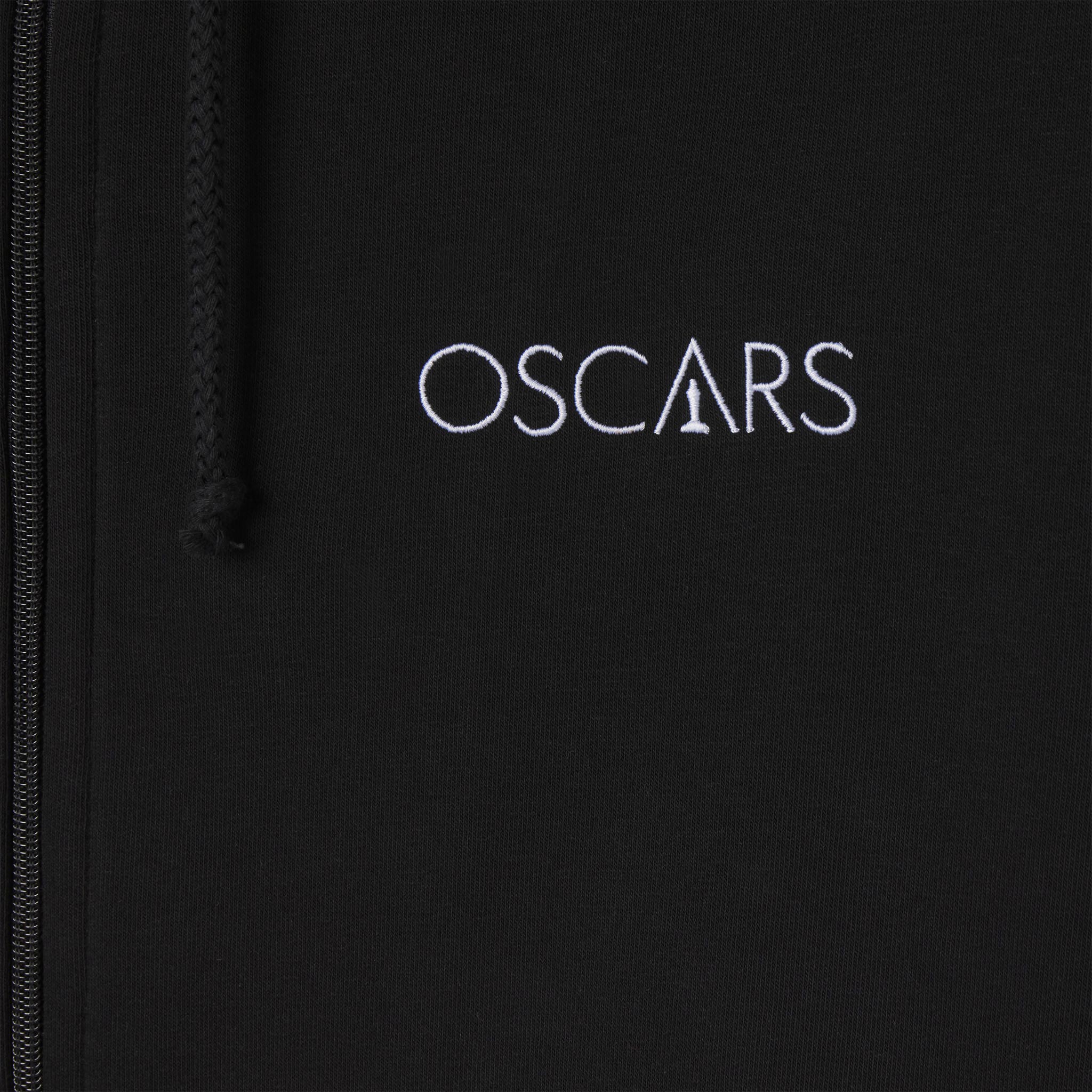 closeup of Black jacket with 'OSCARs' logo embroidered on it