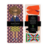 Packaged product with a colorful bow tie and shoe design, featuring the brand 'Ruth Carter'.