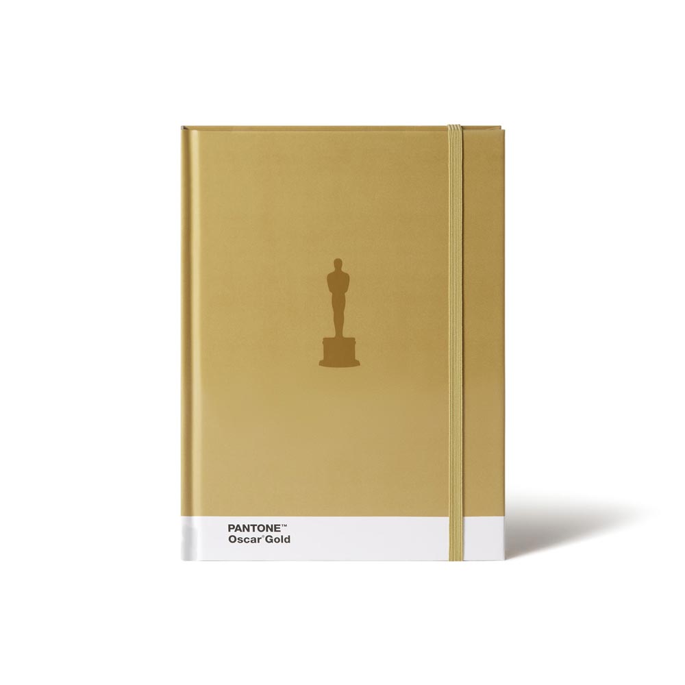 Gold notebook with Oscar statue icon and Pantone branding on a white background