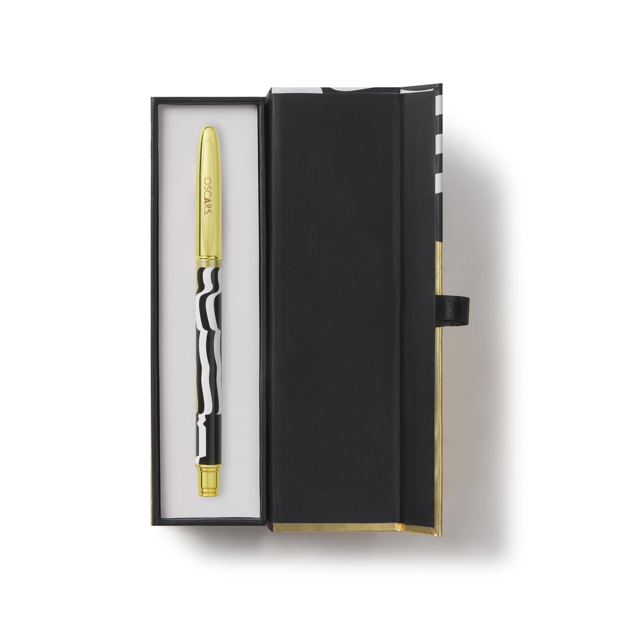 Gold pen in a black box on a white background. Oscar Statue the Academy Awards Show official Oscars Logo Merchandise Collectible ballpoint pen in Oscars logo gift box.