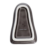 Gray and silver object with 'Studio Ghibli' branding on a white background