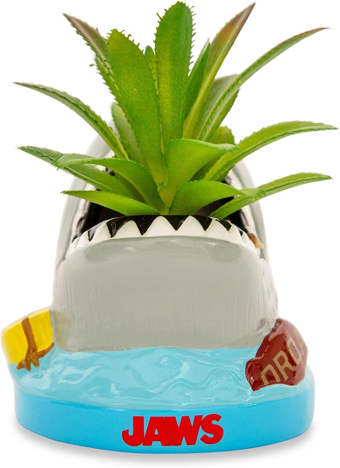 Shark-shaped planter with a plant inside, featuring the 'Jaws' logo.