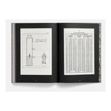Open book displaying technical drawings and tables on a white background