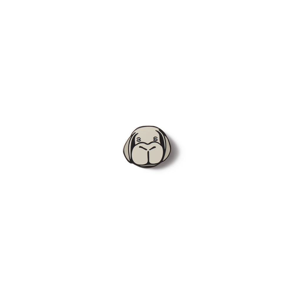 Small round metal lapel pin of Okja from the Bong Joon Ho movie Okja on a white background