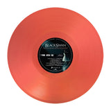 Red vinyl record with a black label featuring 'Black Swan' on a white background