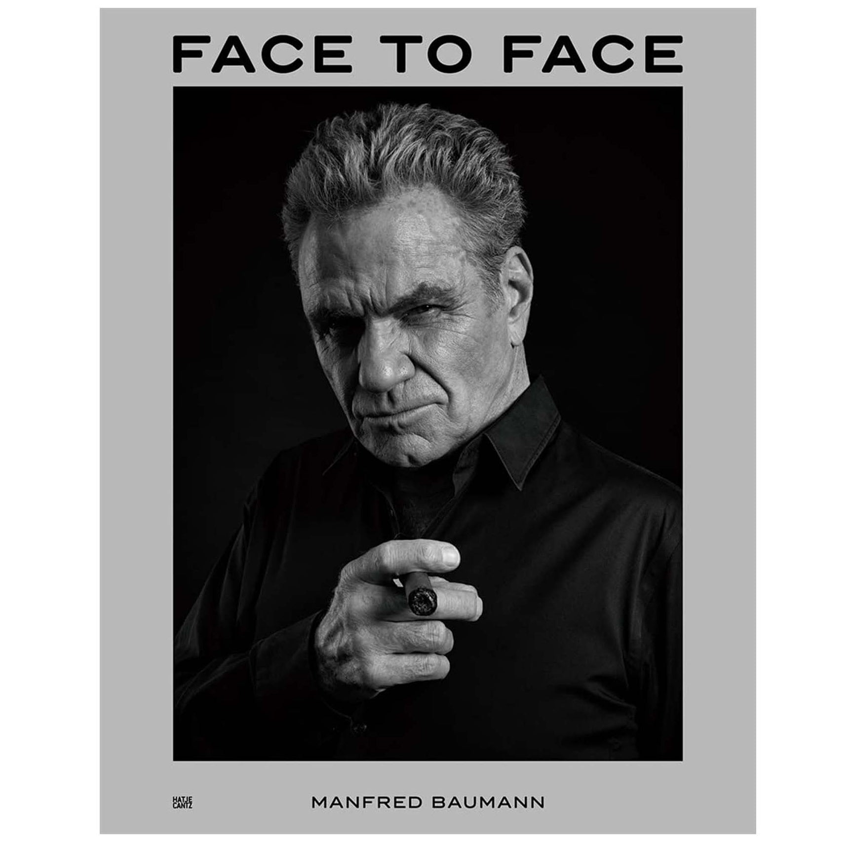 Book cover of 'Face to Face' by Manfred Baumann with a black and white portrait of a man.