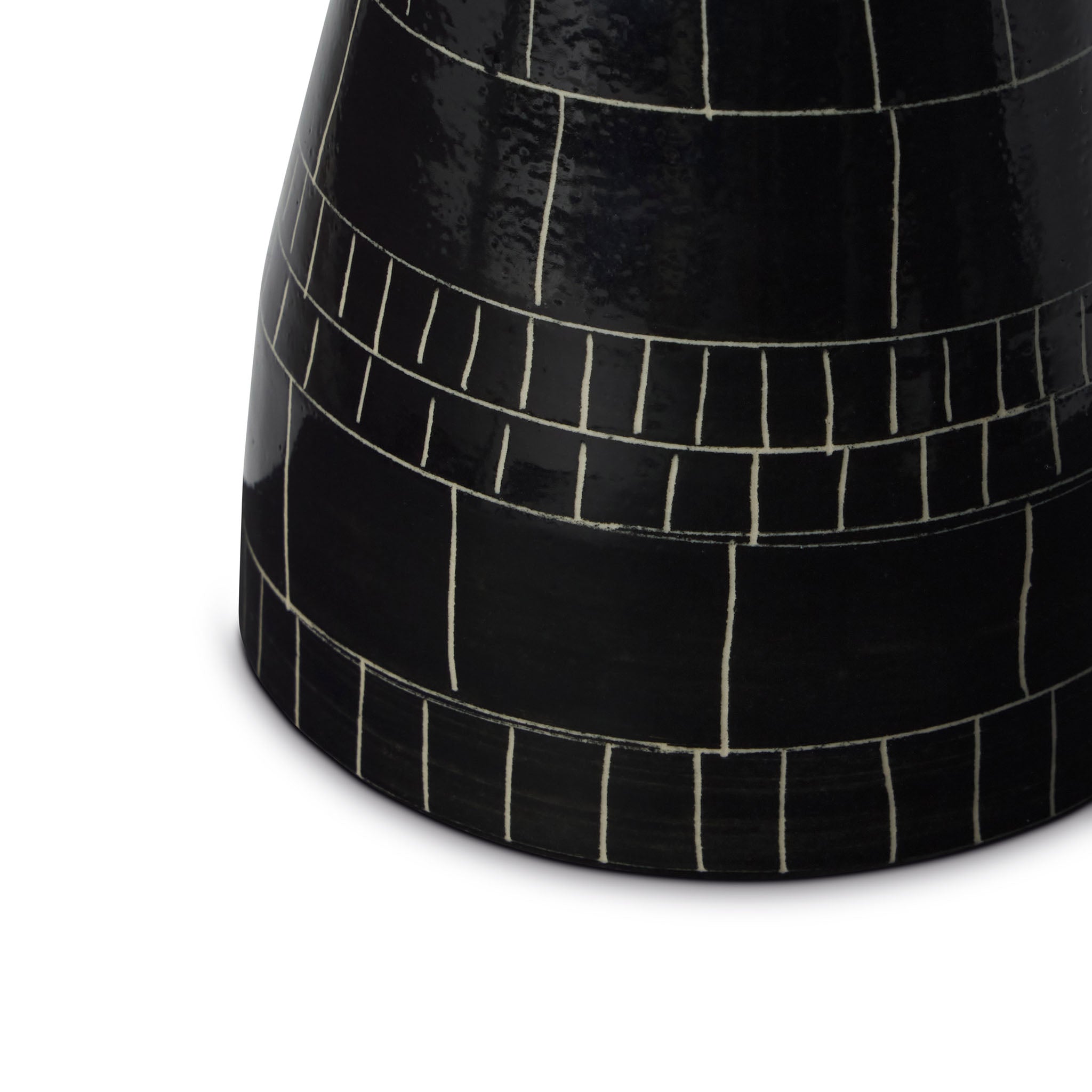 Black ceramic vase with white line pattern on a white background Explore the artistry of Wayne Perry with this 6in black and white ceramic vase. Handcrafted and signed, each piece showcases unique sgraffito techniques and film strip inspiration.