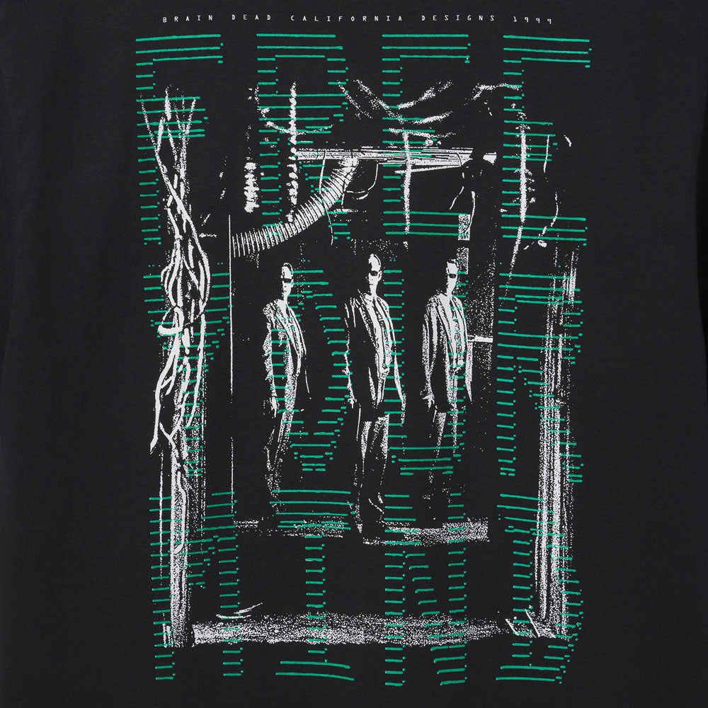 Black t-shirt with graphic design of three figures and green lines on a dark background image of Agent Smith from the movie The Matrix