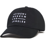 Black cap with 'Academy Museum Los Angeles' text on a white background