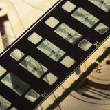 Close-up of a film reel with individual frames showing a person skiing.