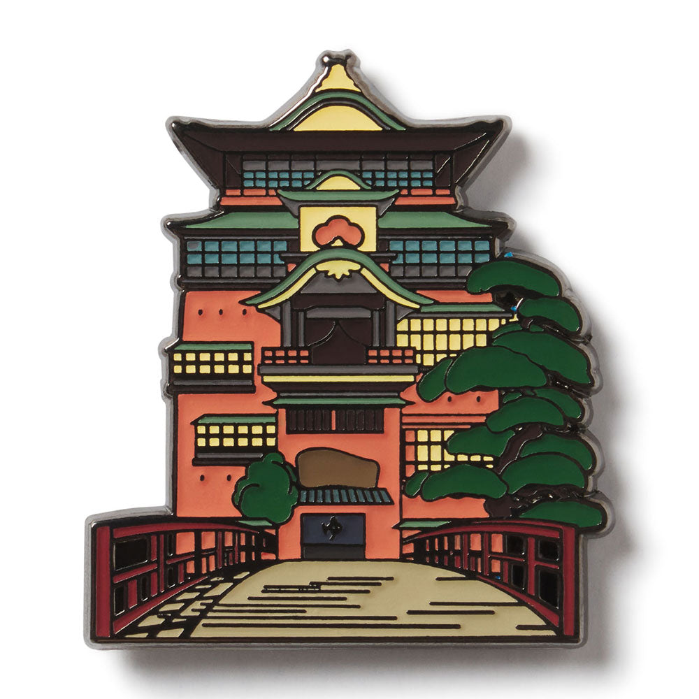 Enamel pin with a design of a traditional Japanese building and tree on a white background. Onsen Bathhouse from Studio Ghibli's Spirited Away enamel lapel pin for the Academy Museum