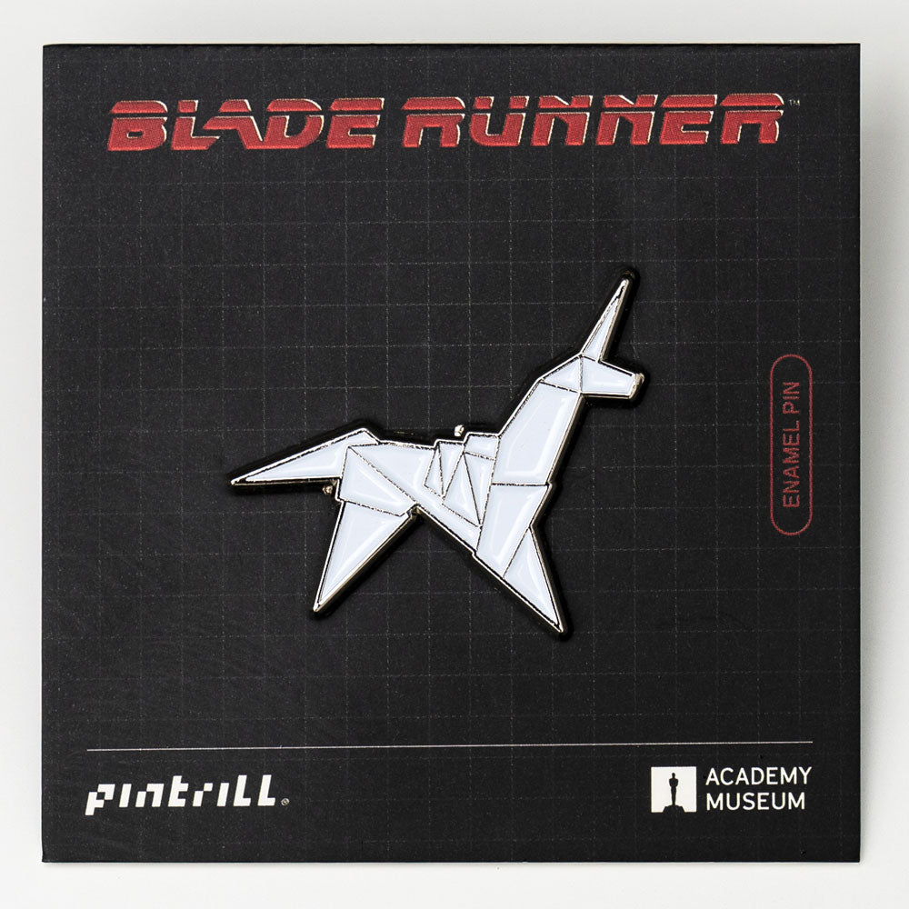 Enamel pin of a blade runner design on a Blade Runner branded card with Pinterrill and Academy Museum logos.