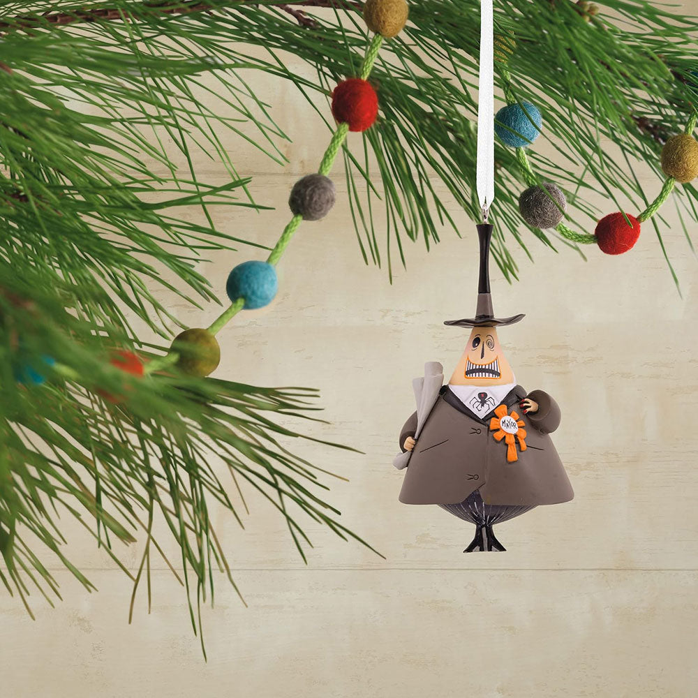 A Hallmark Disney Tim Burton's The Nightmare Before Christmas Mayor Christmas Ornament, featuring a resin depiction of the Mayor of Halloween Town wearing a suit with a spider bow tie and a 'mayor' ribbon, holding a cane, with a hanger attachment at the top.