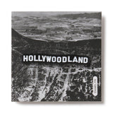 Black and white aerial view of a landscape with 'HOLLYWOODLAND' text overlay.