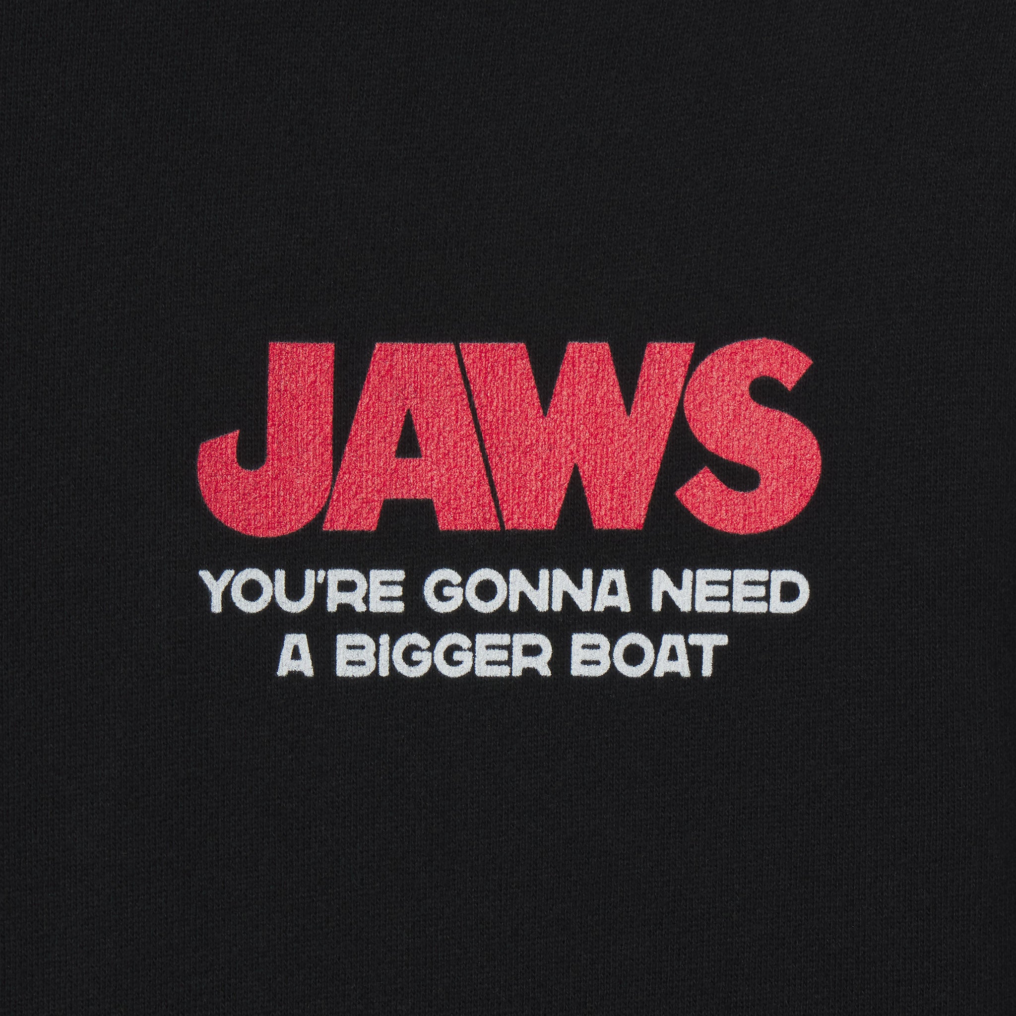 Black t-shirt with red and white 'JAWS' text on a black background