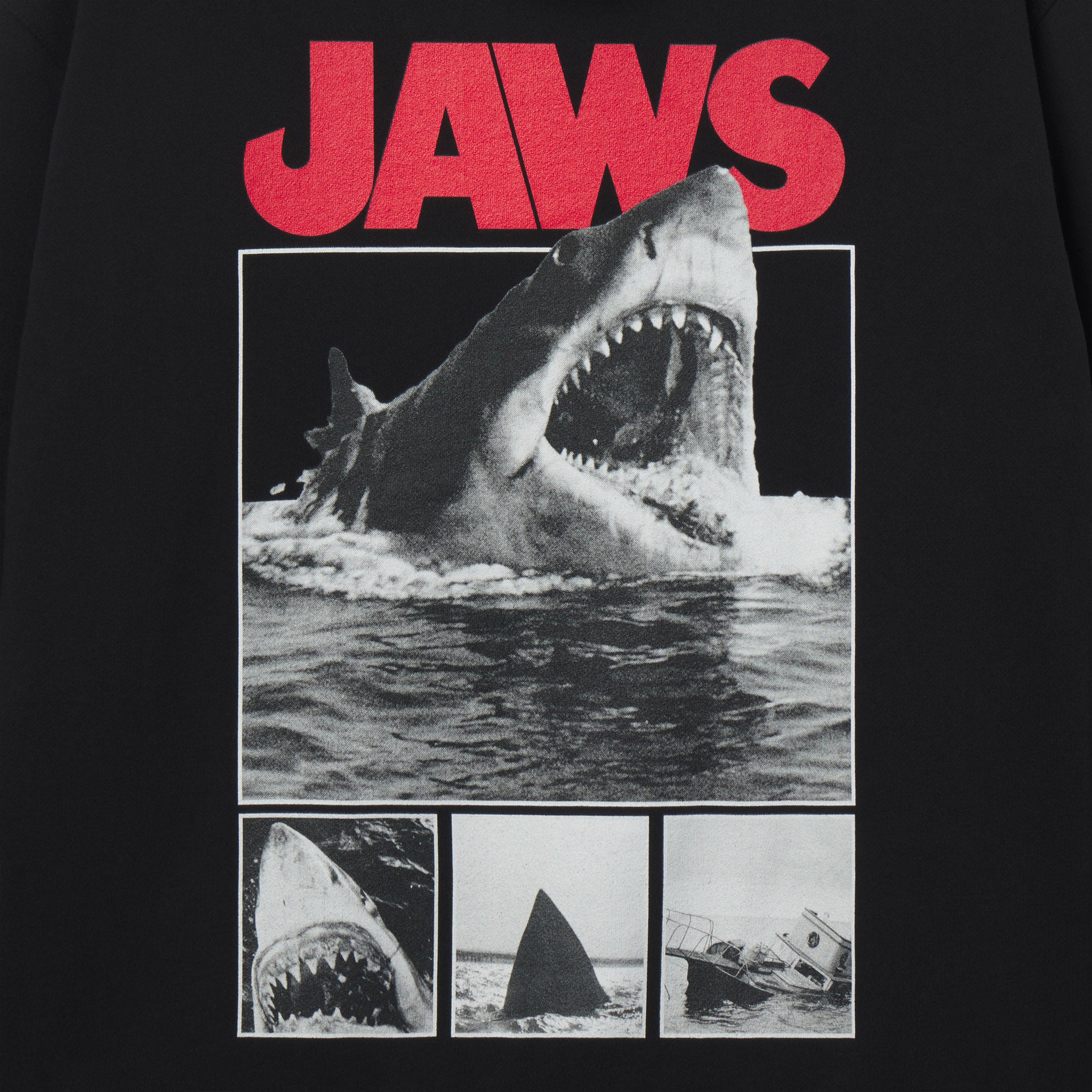 T-shirt with 'JAWS' graphic featuring a shark and movie scenes on a black background.