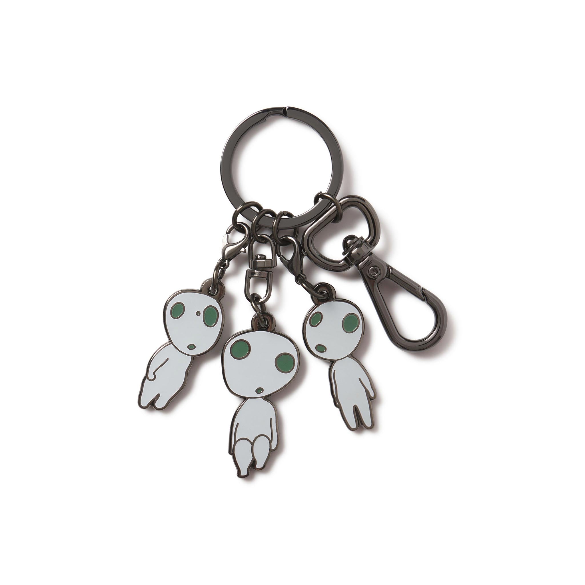 A multicharm keychain featuring three cartoon-style Kodama figures from the movie Princess Mononoke, with a black nickel finish and UV glow details.