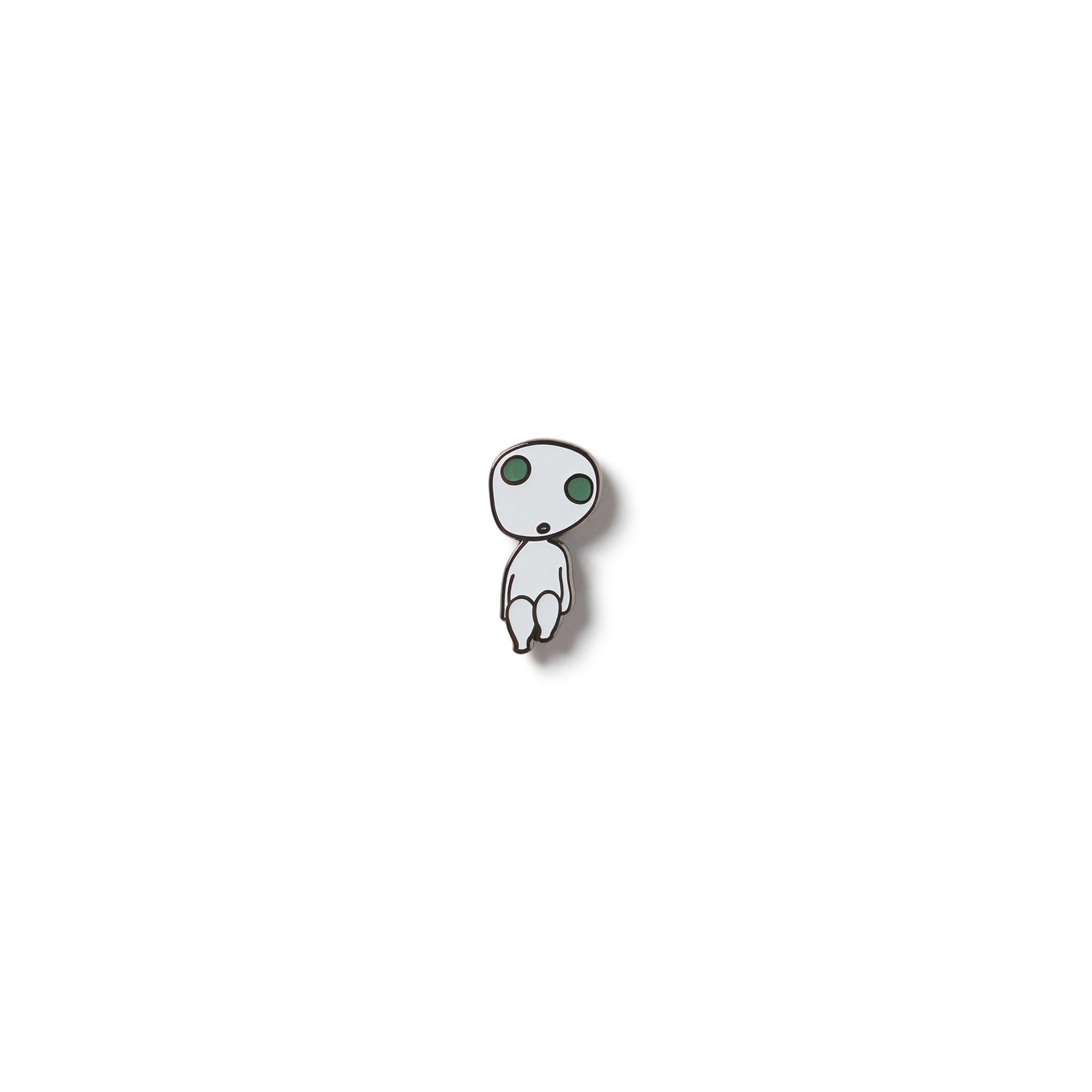 A small enamel pin featuring the character Kodama from the movie Princess Mononoke. The pin is black and white, with the character glowing in the dark.