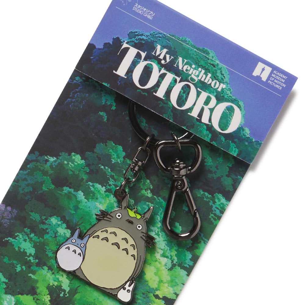 Enamel keychain featuring characters from My Neighbor Totoro, displayed on a card with the movie's title.