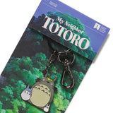 Enamel keychain featuring characters from My Neighbor Totoro, displayed on a card with the movie's title.
