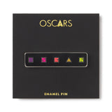 Black box with 'OSCAR' enamel pin design on a white background