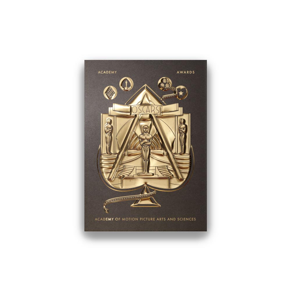 A deck of playing cards with gold foil detailing and an Oscar statuette design on the packaging.