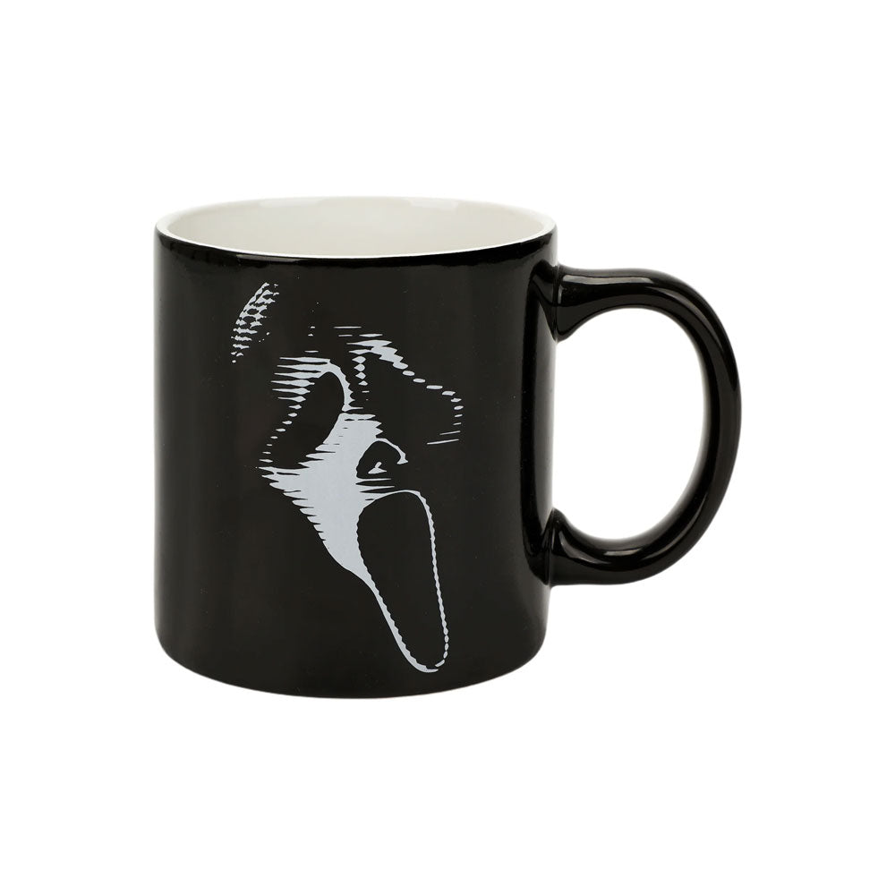 Black mug with a white face design on a white background. Sip your favorite drink in style with our Ghost Face Lives 16 Oz. Ceramic Mug! Perfect for Scream fans, it's microwave and dishwasher safe for easy care.