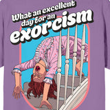 T-shirt with a graphic of a person exorcising a demon and text 'What an excellent day for an exorcism' on a purple background. Embrace the chilling vibe of THE EXORCIST (1973) with our unisex T-shirt featuring Regan's iconic backbend and the quote, "What an excellent day for an exorcism."