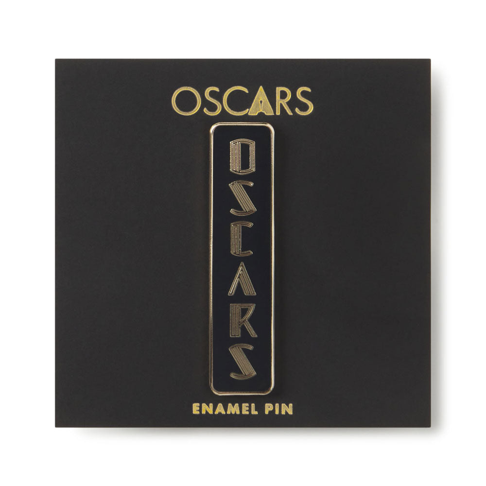 Gold 'OSCAR'S' enamel pin on a black card