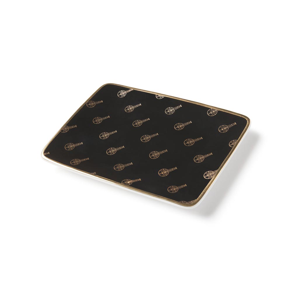 Top angle view of the black rectangle ceramic plate with all over vintage academy awards logo in gold.