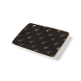 Top angle view of the black rectangle ceramic plate with all over vintage academy awards logo in gold.