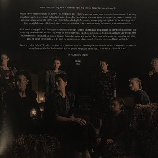 Group of people sitting together in a dark setting with text overlay