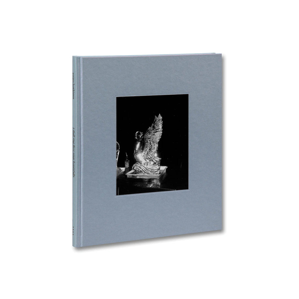 A hardcover book with a gray cover featuring an embossed image and text, titled 'I SHALL SING THESE SONGS BEAUTIFULLY'.