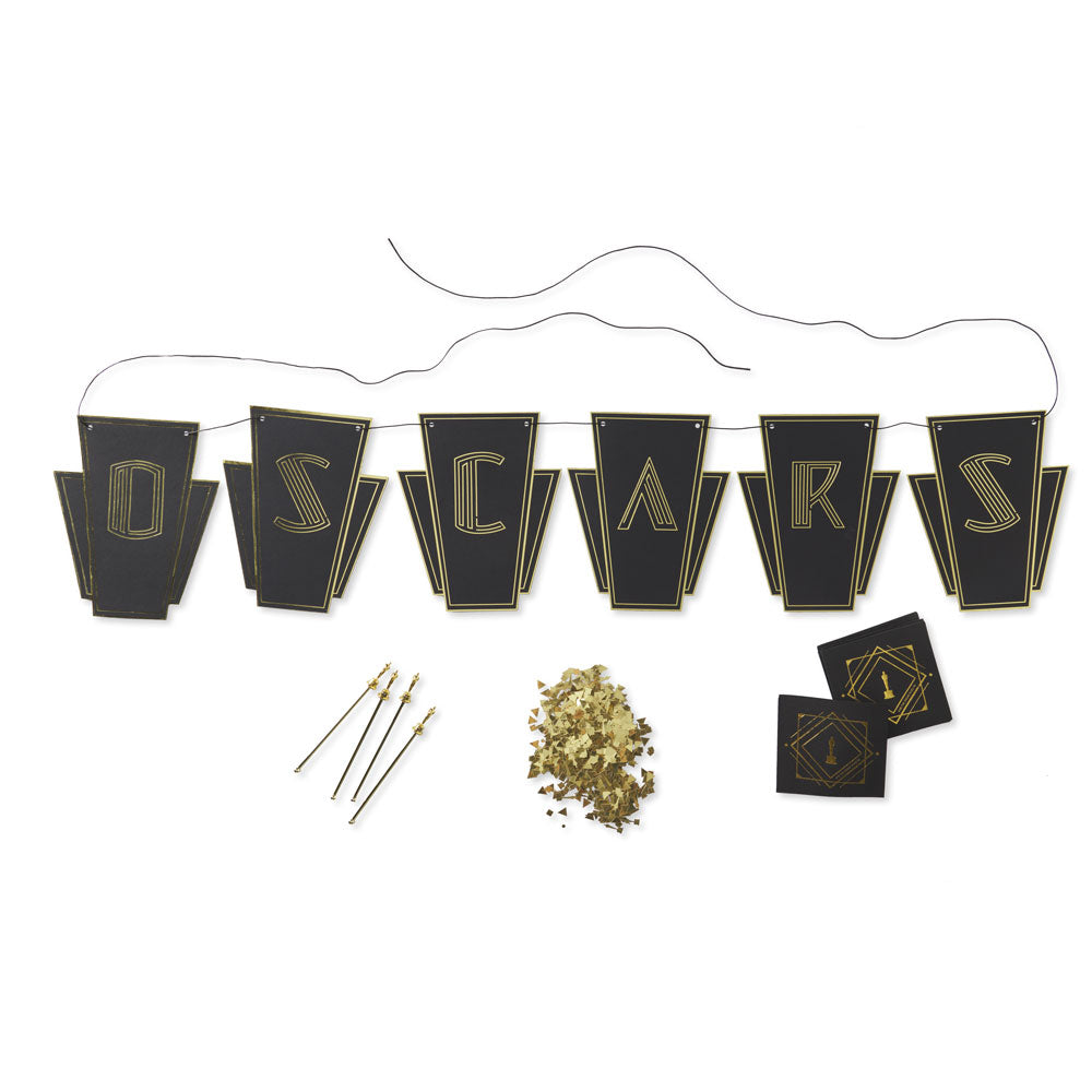 Decorative banner with 'Oscars' letters on black flags, pins, and gold confetti on a white background. Home Viewing Party Kit with banner, drink stirrers, confertti and coasts all with Oscars logo