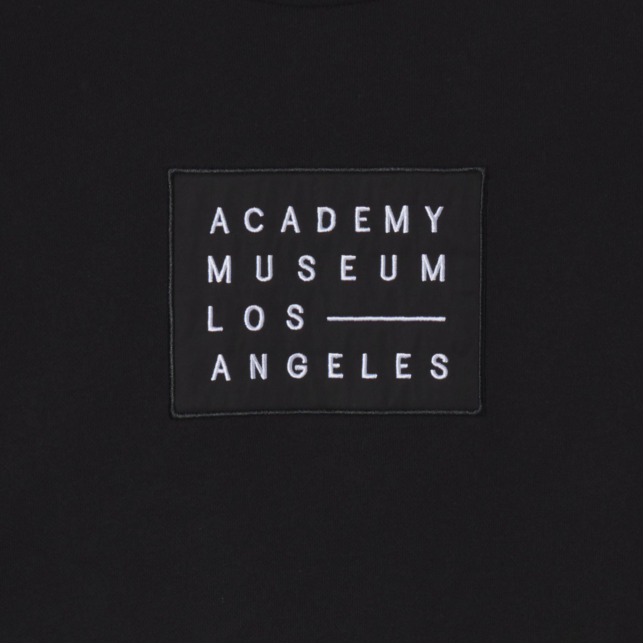 Black patch with 'Academy Museum Los Angeles' text on a black background