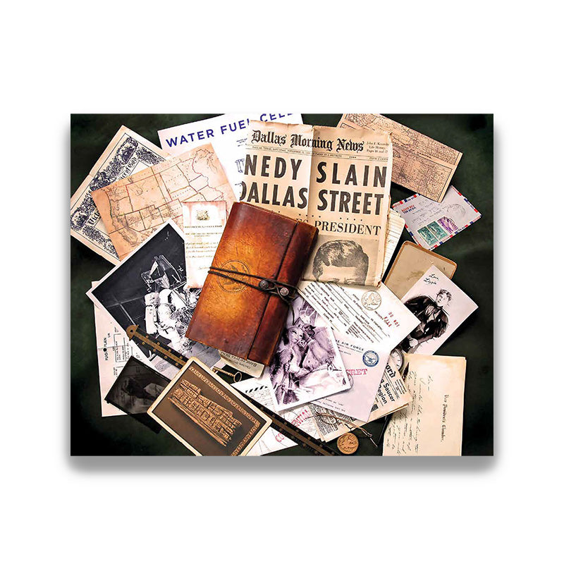 Brown leather journal surrounded by vintage newspapers and documents on a dark surface